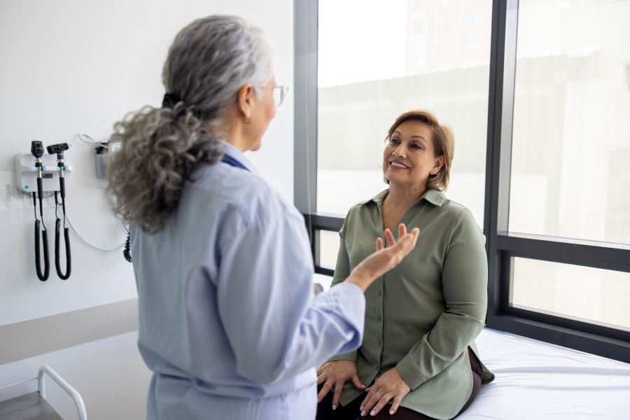 Getty image of doctor talking to a mature women in a consultation